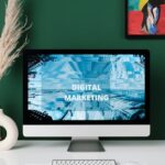 A contemporary office desk with computer screen showcasing digital marketing content.