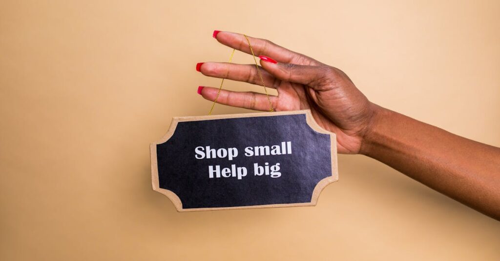 Close-up of a hand holding an inspiring sign encouraging small businesses support.